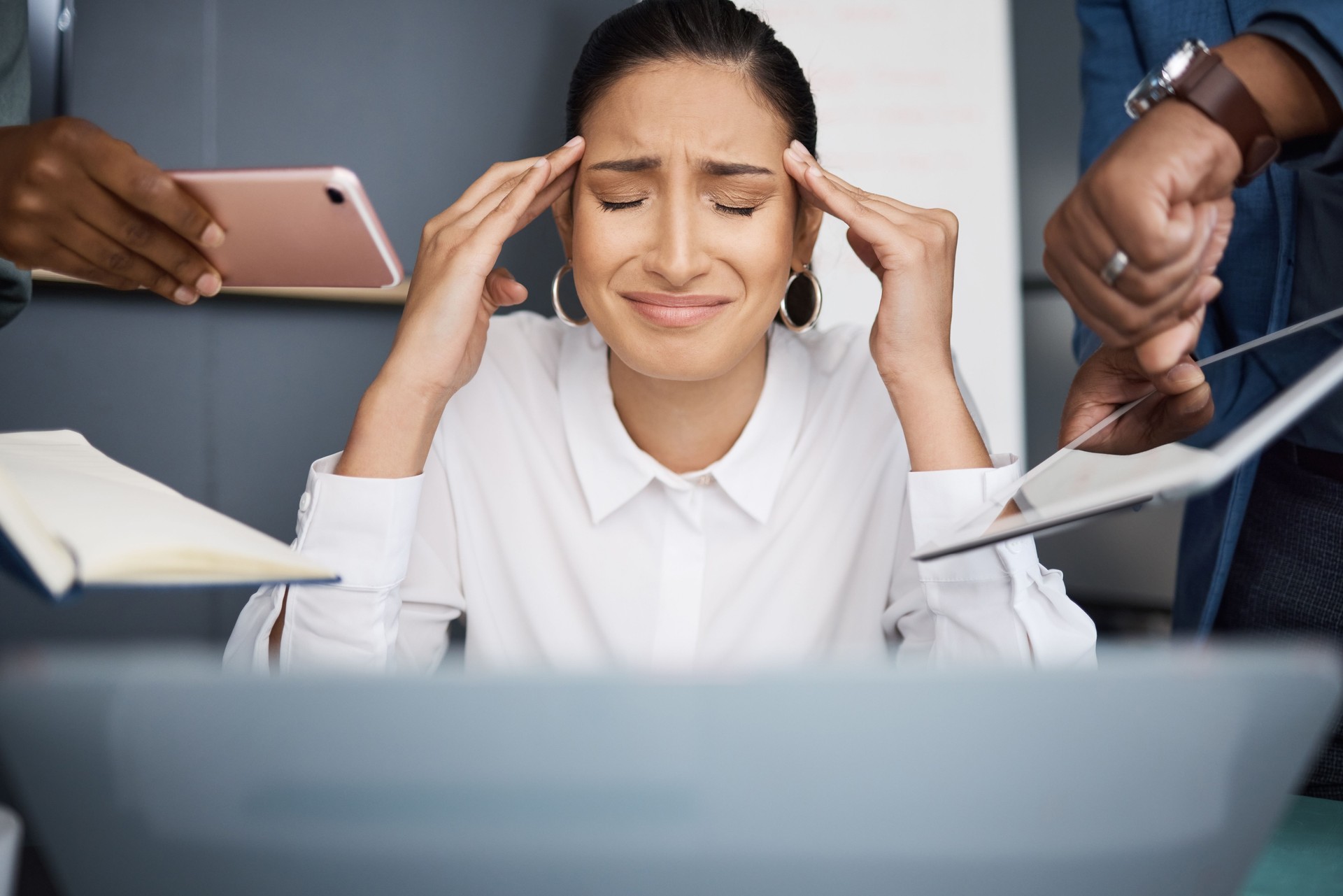 Shot of a young businesswoman looking stressed out in a demanding office environment